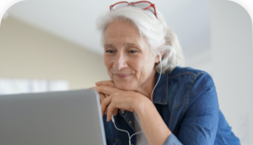 Image of woman in blue shirt looking at a laptop